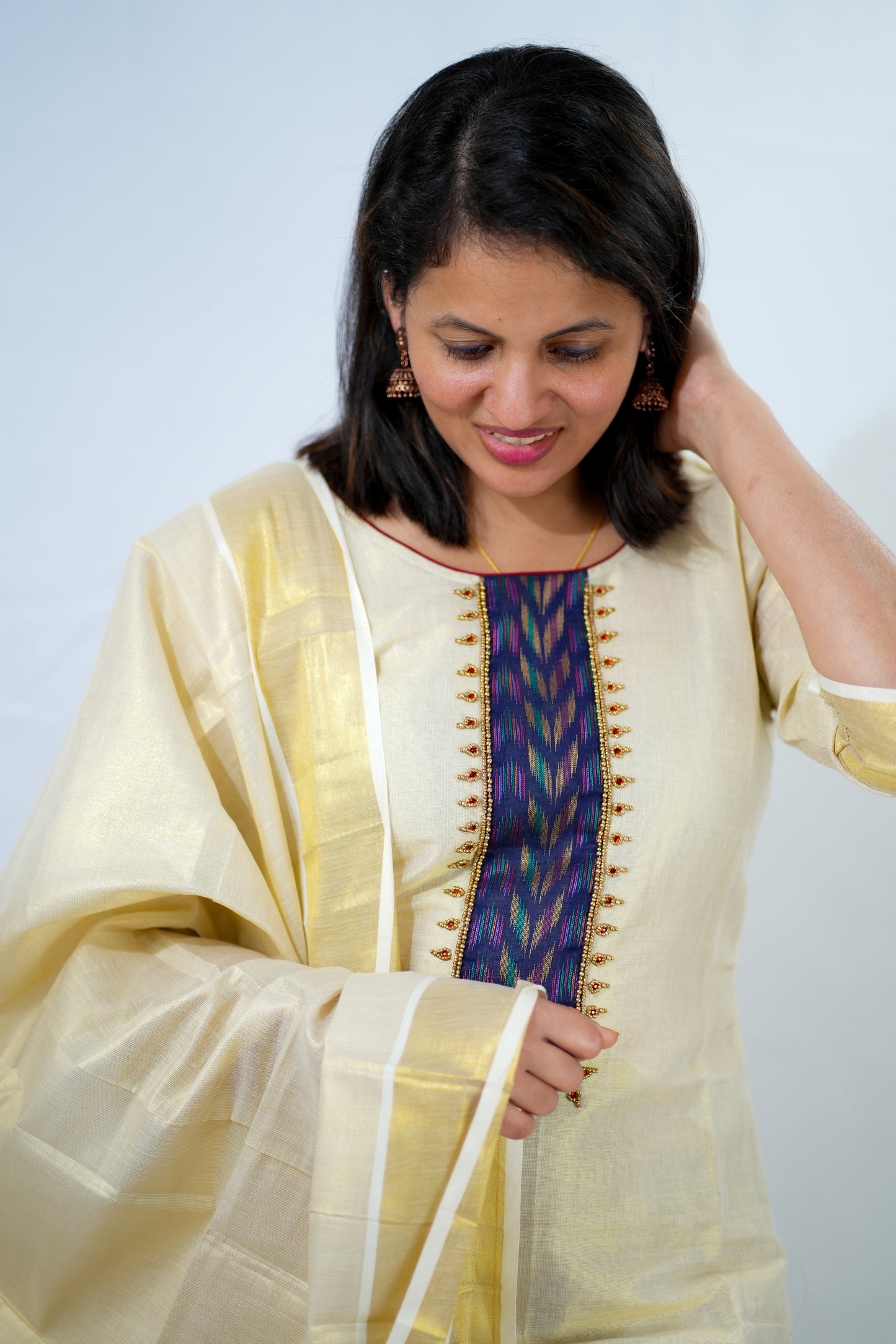 Kasavu Churidhar with violet design and beads
